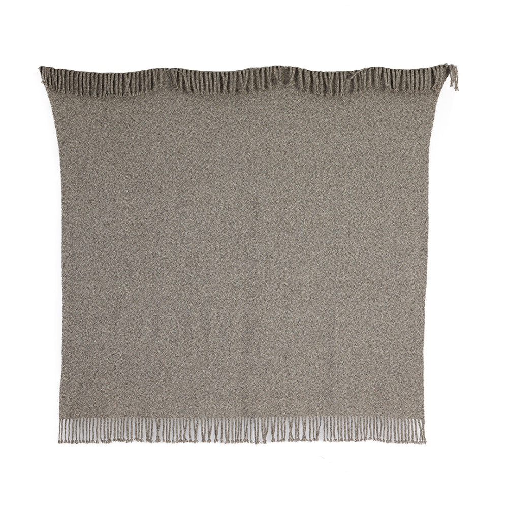 A graphite gray throw made from organic pima cotton and undyed baby alpaca, handwoven on a loom, with fringes on the edges.