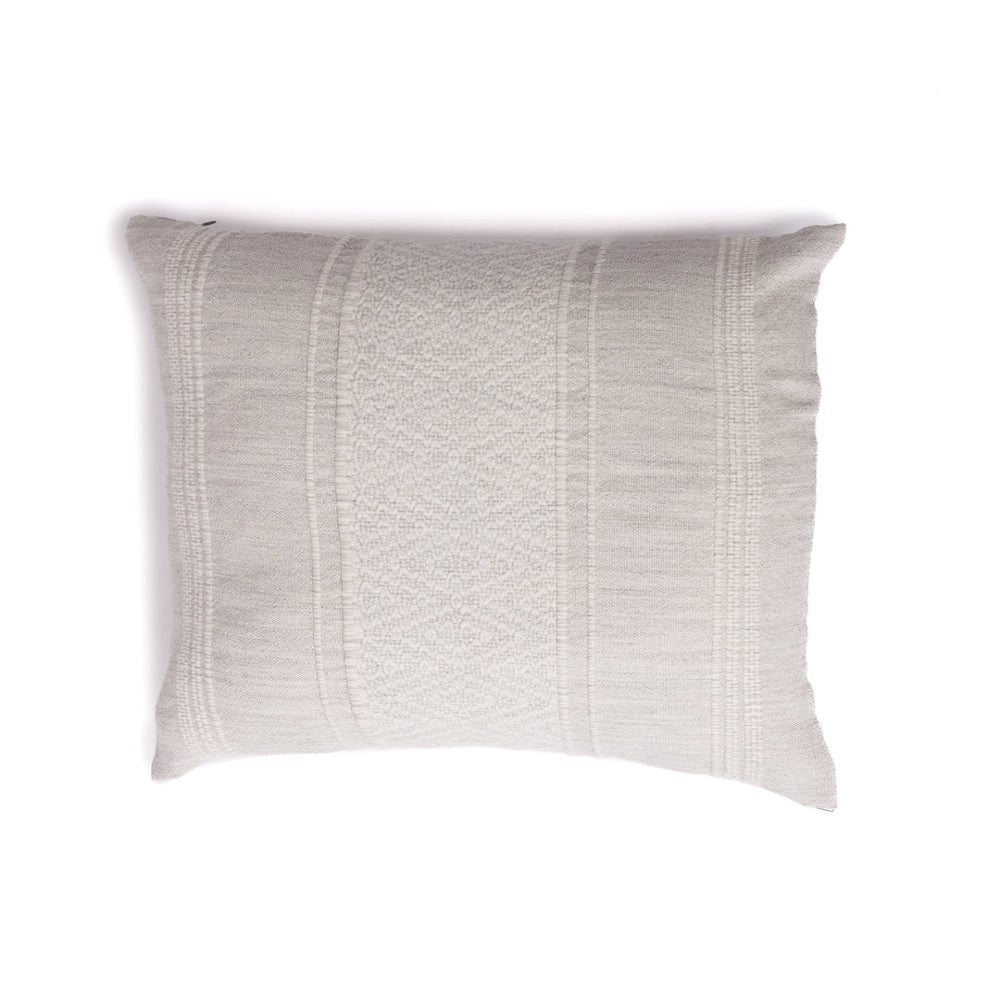 A handloomed alpaca fiber pillow in gray and ivory with a geometric pattern.