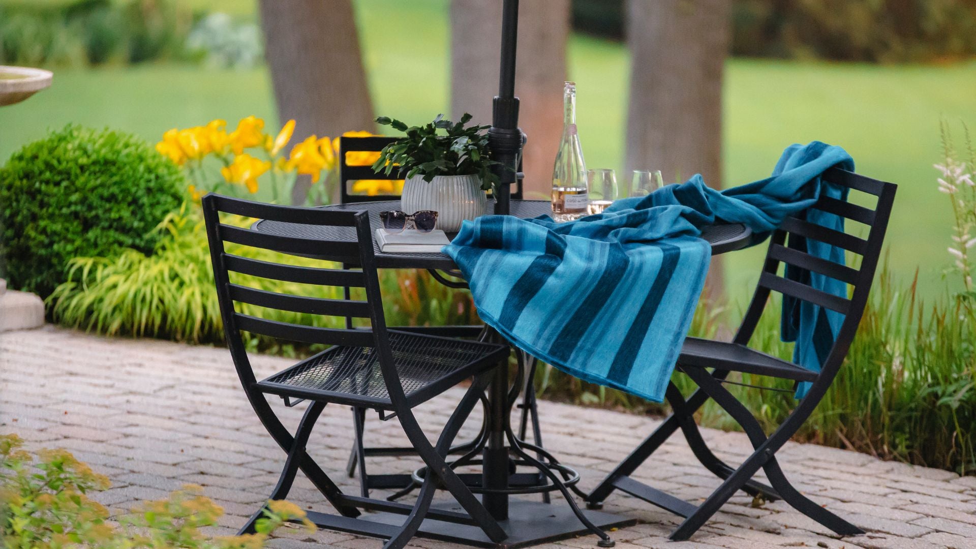 A set of patio furniture featuring a table, chairs, and an umbrella for outdoor dining.