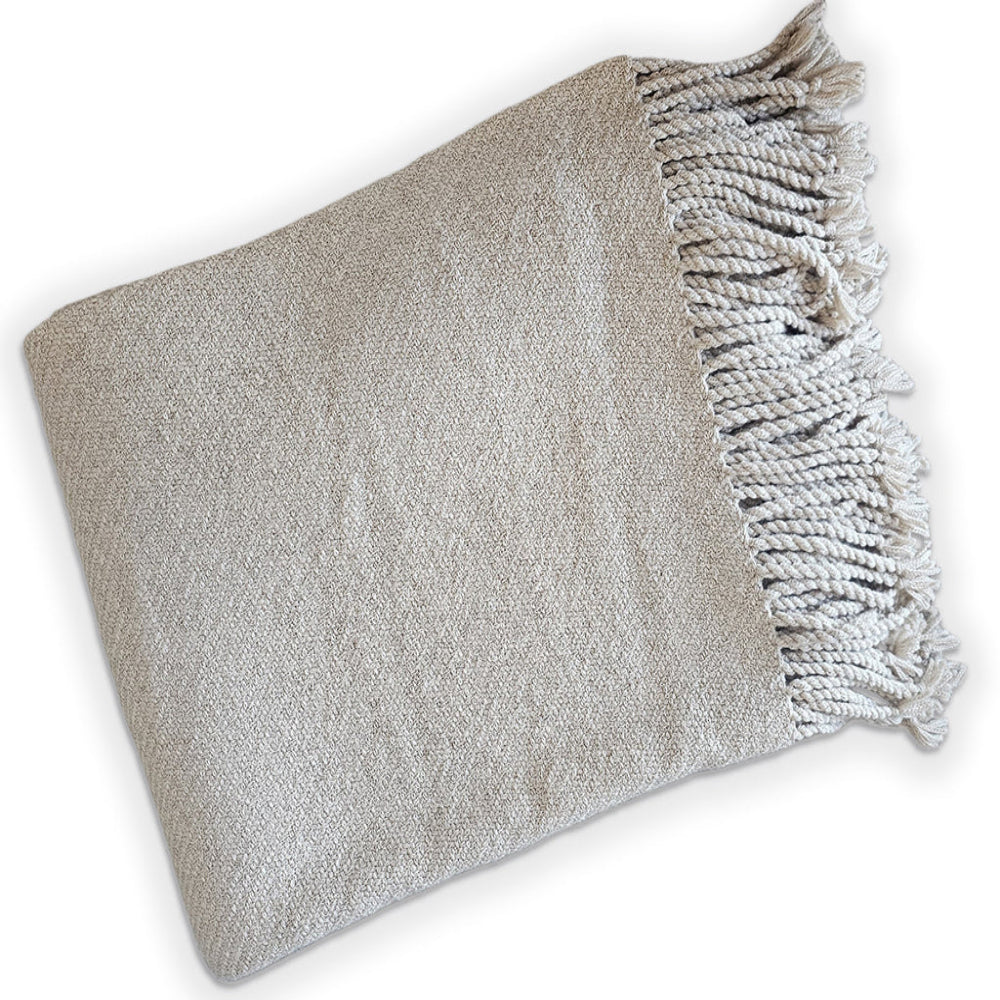 Gray woven blanket with fringed edge on a white background