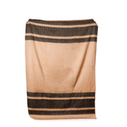 A woven throw blanket in peach and charcoal colors with a solid pattern and no visible texture.