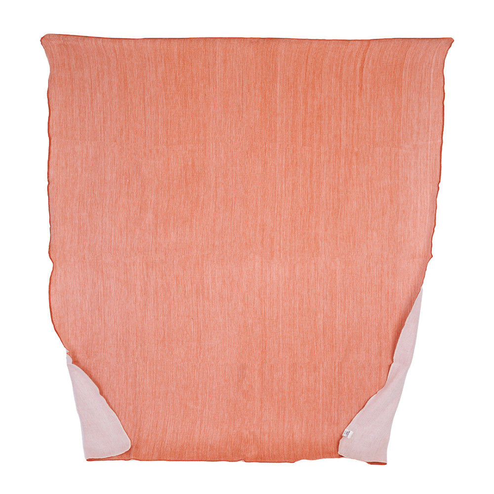 A reversible melon and white throw blanket woven from alpaca yarns, displayed flat.