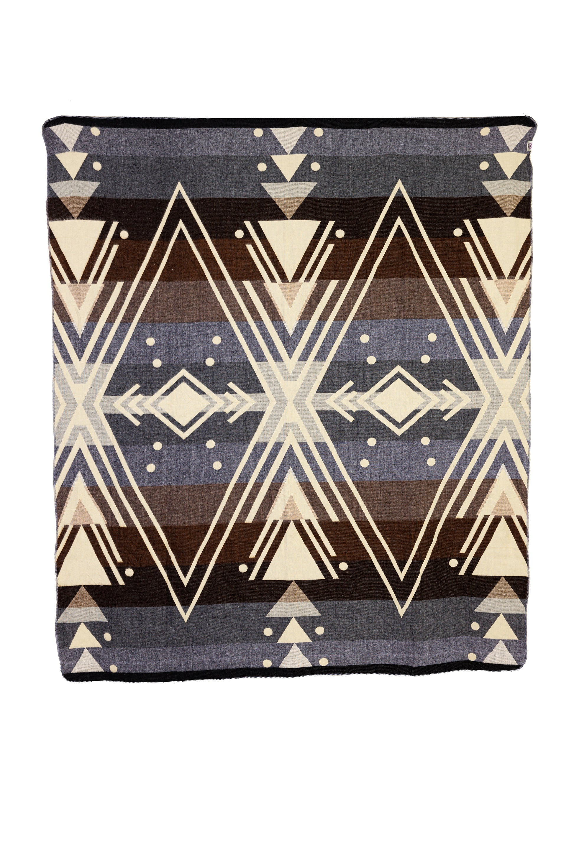 A woven alpaca blanket with a geometric chevron pattern in gray, brown, black, and cream colors.