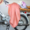 Pink handwoven throw on bike