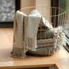 Beige artisanal woven throw on chair