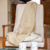 Beige handwoven throw on chair