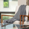 Light grey artisanal woven throw on bench