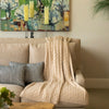 Beige artisanal woven throw on sofa
