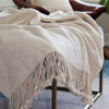 cream textured throw blanket with fringe