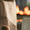 beige fringe throw blanket close-up