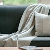 grey artisanal woven throw on sofa