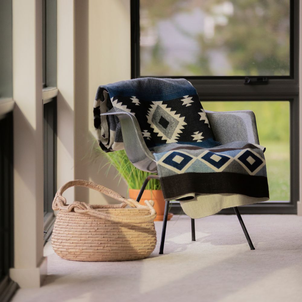 Chic blue geometric blanket in cozy reading nook