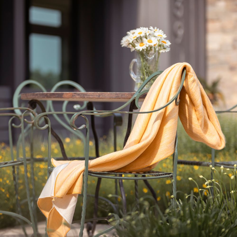 A chair featuring a neatly placed blanket, enhancing its comfort and inviting use.