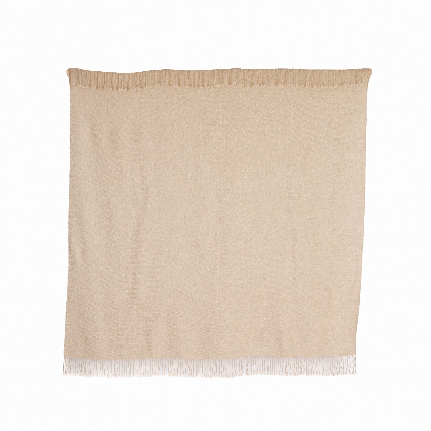 A beige, undyed ivory mist baby alpaca throw with fringes displayed against a white background.