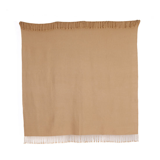 A light tan baby alpaca throw with fringes, handwoven and displaying natural fiber texture.