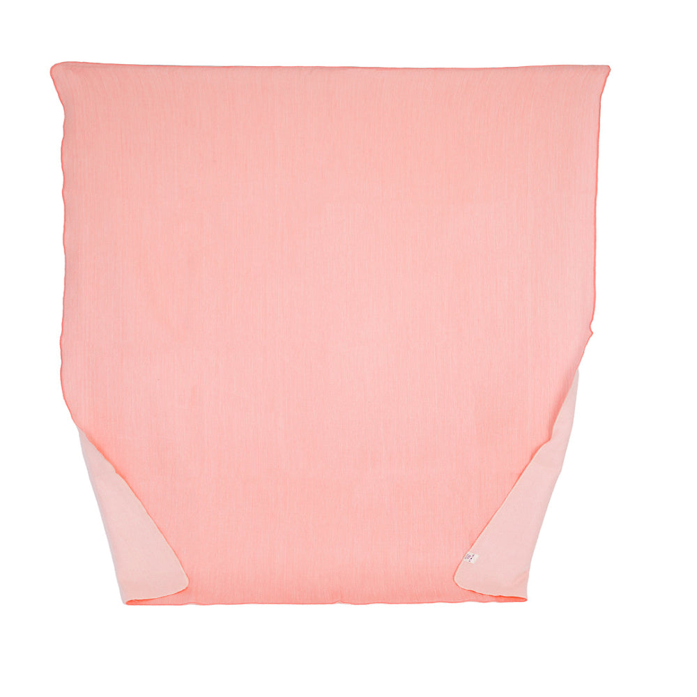 A reversible pink and white throw blanket woven from alpaca yarns, displayed on a plain background.